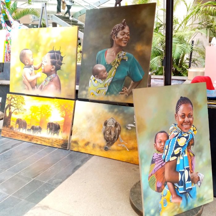 Collection of five paintings: three depicting African mothers caring for their children, and two featuring African wildlife - By Daniel Njoroge